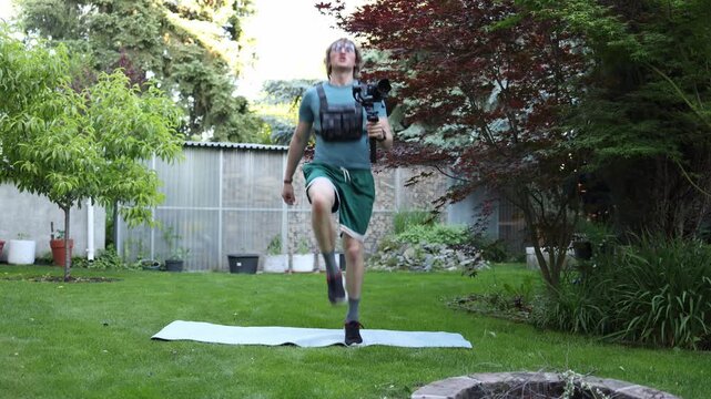 Videographer performs high knee running with a camera gimbal improving cardio endurance coordination and stamina required for dynamic handheld filming work
