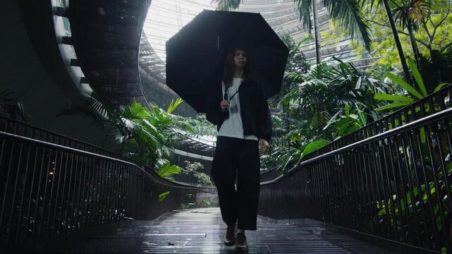 Woman with an umbrella walking in singapore airport