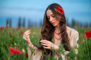 young woman in poppy field © Maksym Dykha
