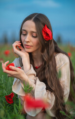 young woman in poppy field © Maksym Dykha