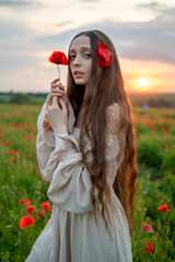 young woman in poppy field © Maksym Dykha