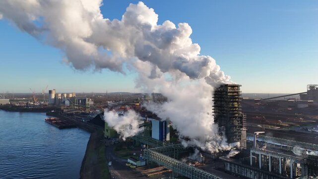Pullback above river opening the smoking plant scene