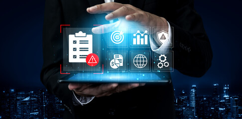 A business professional engages with a tablet displaying digital icons related to analytics,...