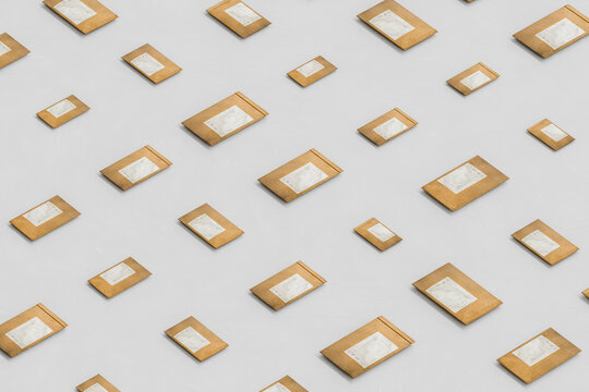 3D shipping envelope pattern arranged on a minimal white floor