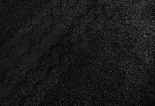 Close up black tire marks on cement floor.