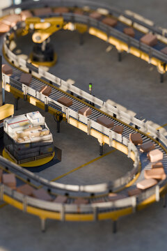 3D automated conveyor system sorting parcels with robotic arms.