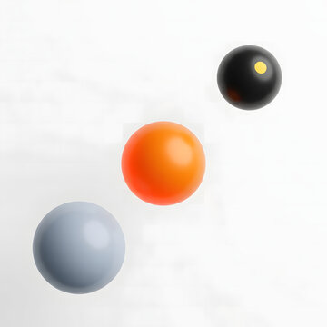 Three smooth glossy spheres featuring distinct colors of grey orange and black with a small yellow dot floating diagonally against a clean white background in a minimalist digital art composition.