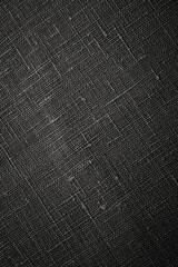Fototapeta premium Black textured surface with fabric-like pattern shown in a close-up view under even lighting