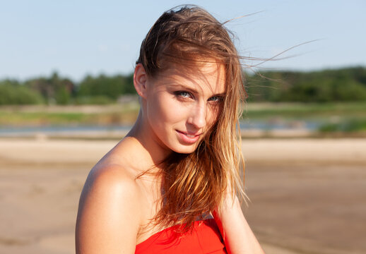 Young woman posing outdoors wearing red