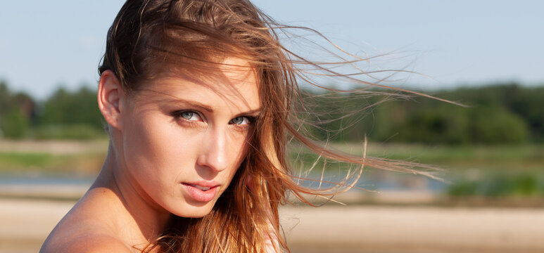 Young Woman With Windblown Hair Outdoors