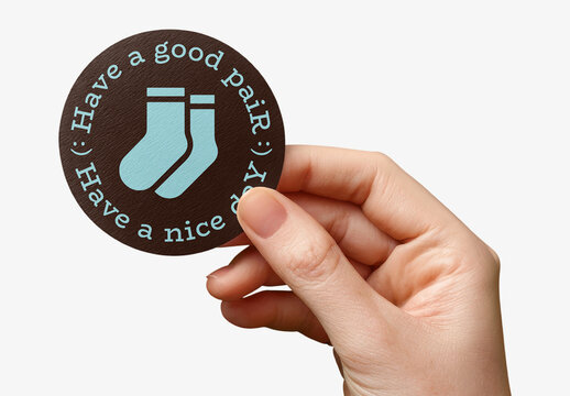 Hand Holding Circular Sock Sticker Mockup PSD