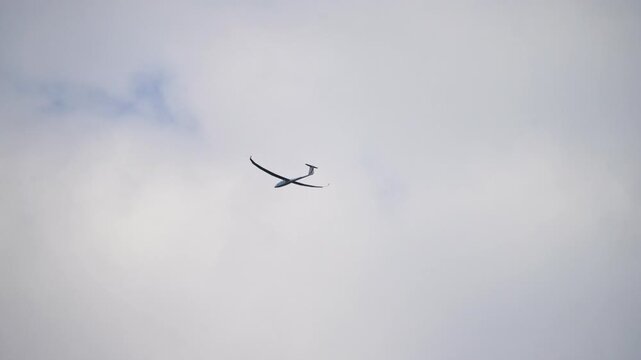 Minimal blue sky background with flying glider