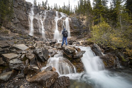 Hiker at Tangle Creek Falls, in autumn, Jasper National Park, Alberta, Canada (Hiker) at Tangle Creek Falls, in autumn, Jasper National Park, Alberta, Canada
