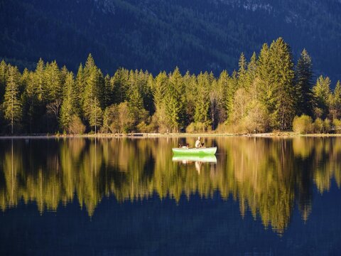 Angler in a rowing boat on the Hintersee in the first sunlight, Berchtesgaden National Park, Ramsau, Berchtesgadener Land, Upper Bavaria, Bavaria, Germany