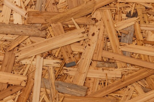Abstract view of chipboard surface. Wood chips and planks are pressed together to create a textured brown material. Great for backgrounds and construction themes.