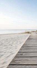 Obraz premium Minimalist wooden boardwalk on a quiet beach with copy space