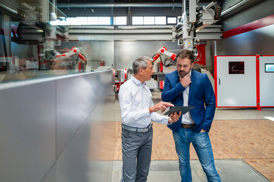 Manager and engineer planning with tablet in automation factory