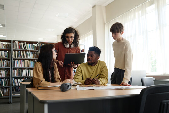 Students having discussion together in library