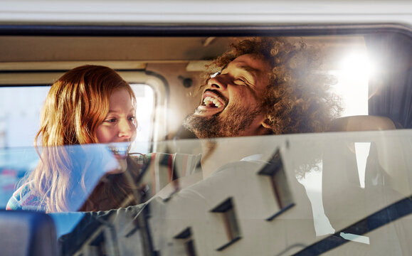 Happy young couple in a car