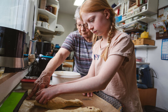 Family baking dough together in a home kitchen