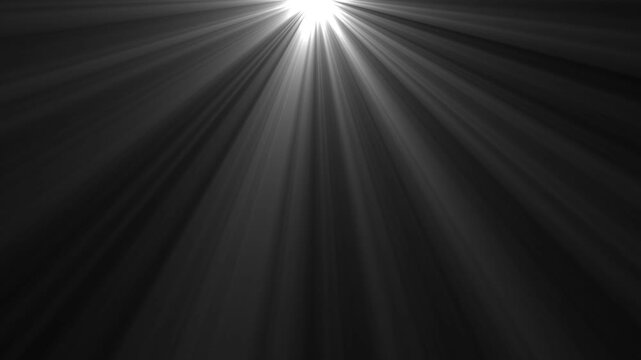 Light rays volumetric beam loop overlay effect from top center spotlight sunburst optical lens flare shining abstract motion graphic background isolated on black backdrop.