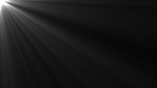Light rays volumetric beam loop overlay effect from top left corner flashing sunburst optical lens flare shining abstract motion graphic background isolated on black backdrop.