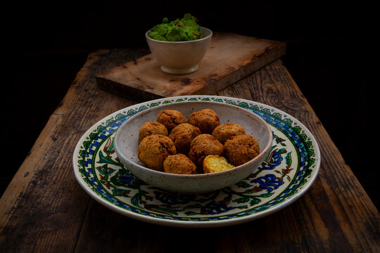 Falafel with pea hummus and chili on an ornamented plate