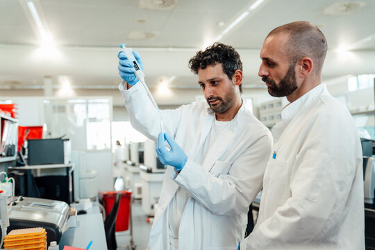 Scientists analyzing liquid sample in laboratory