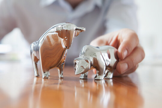 Miniature sculptures of bull and bear on a desk