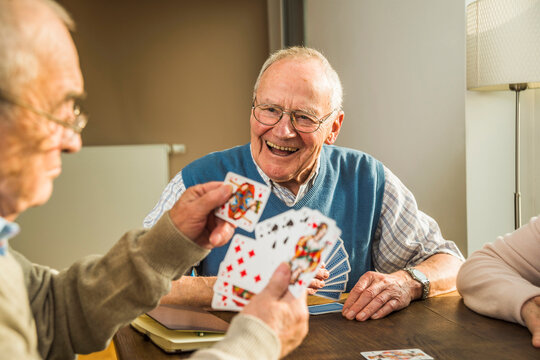 Senior friends playing cards