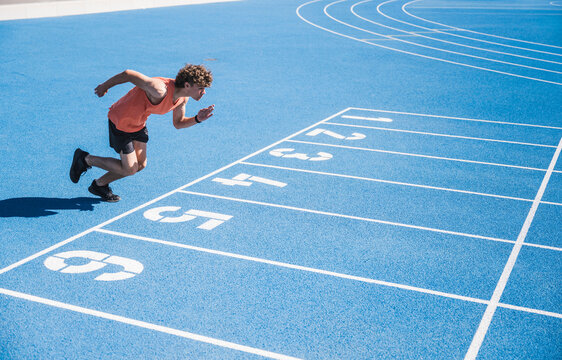 Young athlete running on track