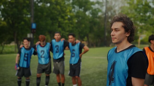 Football Player Scoring Goal and Celebrating with Team on the Field