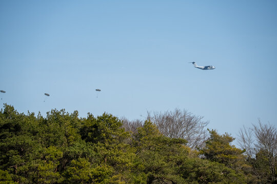 ZM401 RAF Royal Air Force Airbus C.1 A400M Atlas military cargo plane on a low-level cargo parachute drop exercise, blue sky light cloud