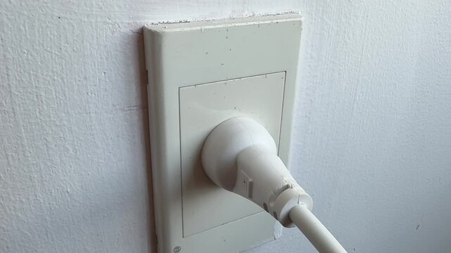 Close-up video of a standard electrical wall outlet in a home or office interior. Everyday utility concept representing electricity, power supply, household infrastructure and modern living.