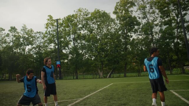 Football Player Scoring Goal and Celebrating with Team on the Field