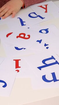 The child learns English letters. Selective focus.