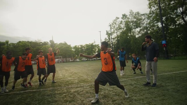 Football Player Scoring Goal and Celebrating with Team on the Field