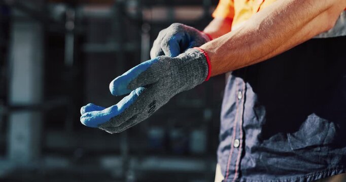 Getting ready, gloves and hands of man on construction site for architecture or civil engineering. Preparation, protection and safety with contractor outdoor for building or property development