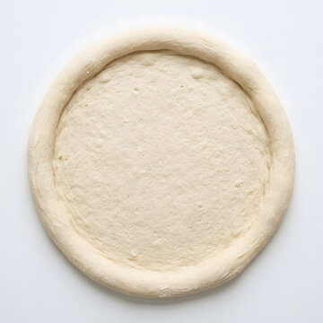 Fresh raw pizza dough base ready for delicious toppings on a clean white kitchen surface background