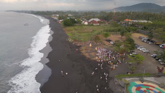 Local Funeral On Black Sand Beach Bali Indonesia Early Morning Drone Track Back 4K 30FPS