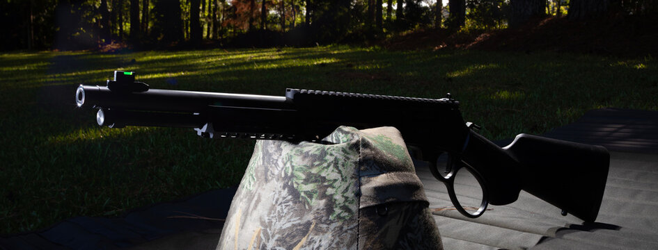 Silohouette of a modern lever action rifle in the outdoors