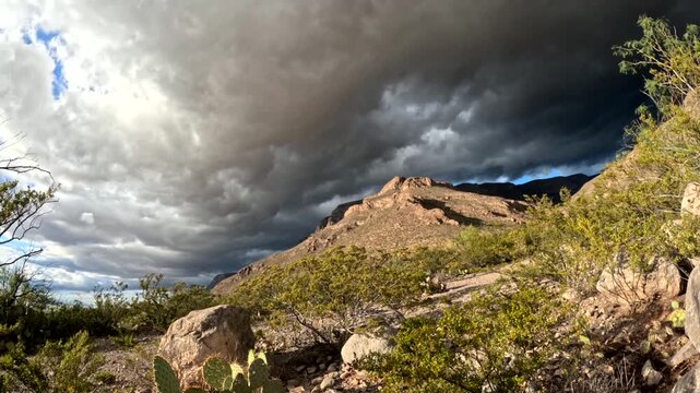 Clouds rolling over mountain top, time lapse video