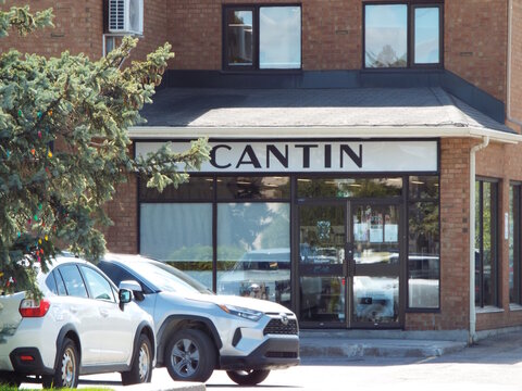 Gatineau, Quebec, Canada &ndash; May 10, 2026: A "Cantin" storefront is shown with a large sign above the entrance, with parked cars in the foreground at 372 Bd Gr&eacute;ber.