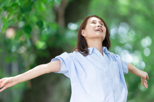 女性　深呼吸　伸び　新緑