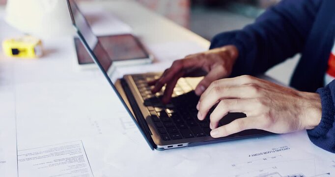 Architect, hands and typing on laptop for planning, design update or schedule for property development. Man, computer and engineer with blueprints for compliance regulations with maintenance research