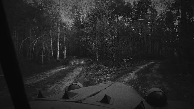 View from Military Vehicle on Dirt Path Through Forested Area