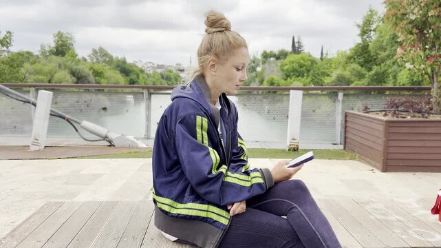 Lifestyle portrait of young woman using a smartphone outdoors