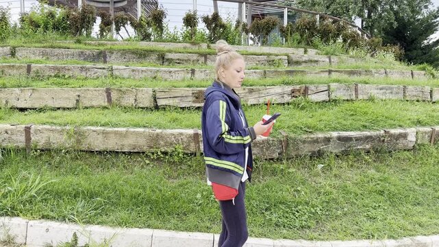 Lifestyle portrait of young woman using a smartphone outdoors