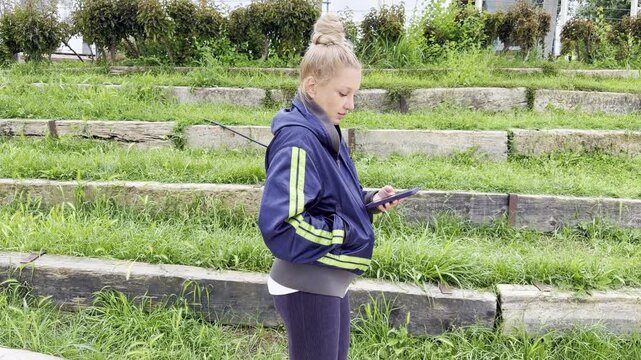 Lifestyle portrait of young woman using a smartphone outdoors
