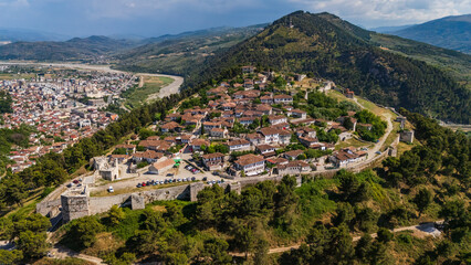 Obraz premium Drone shot of Kalaja e Beratit, the medieval fortress overlooking the historic old town in Albania. Scenic landscape of the famous UNESCO world heritage site from above